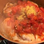 Adding tomatoes and chicken bouillon