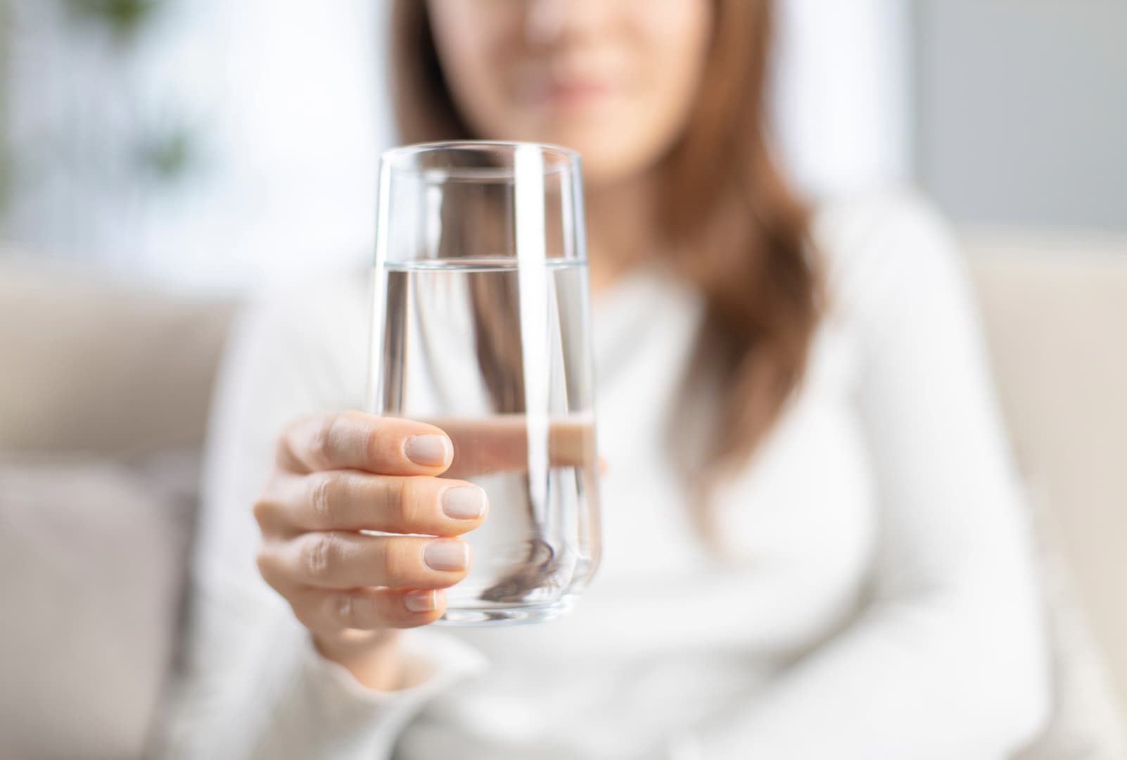 image of a woman holding a glass of water