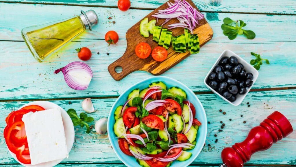 image of the ingredients for a Greek salad on cutting boards