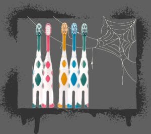 Halloween Sugar image of toothbrushes behind a spider web