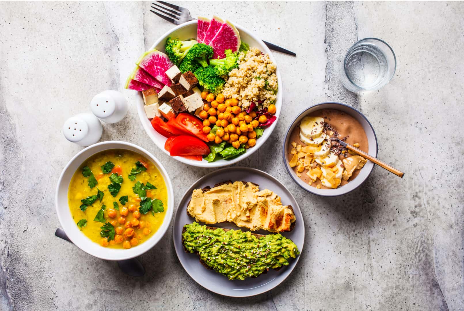 Image of a vegan meal with four dishes all made from plant-based foods