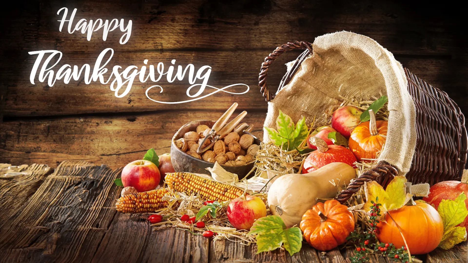 An image of a basket with vegetables falling out including nuts and apples to celebrate the harvest