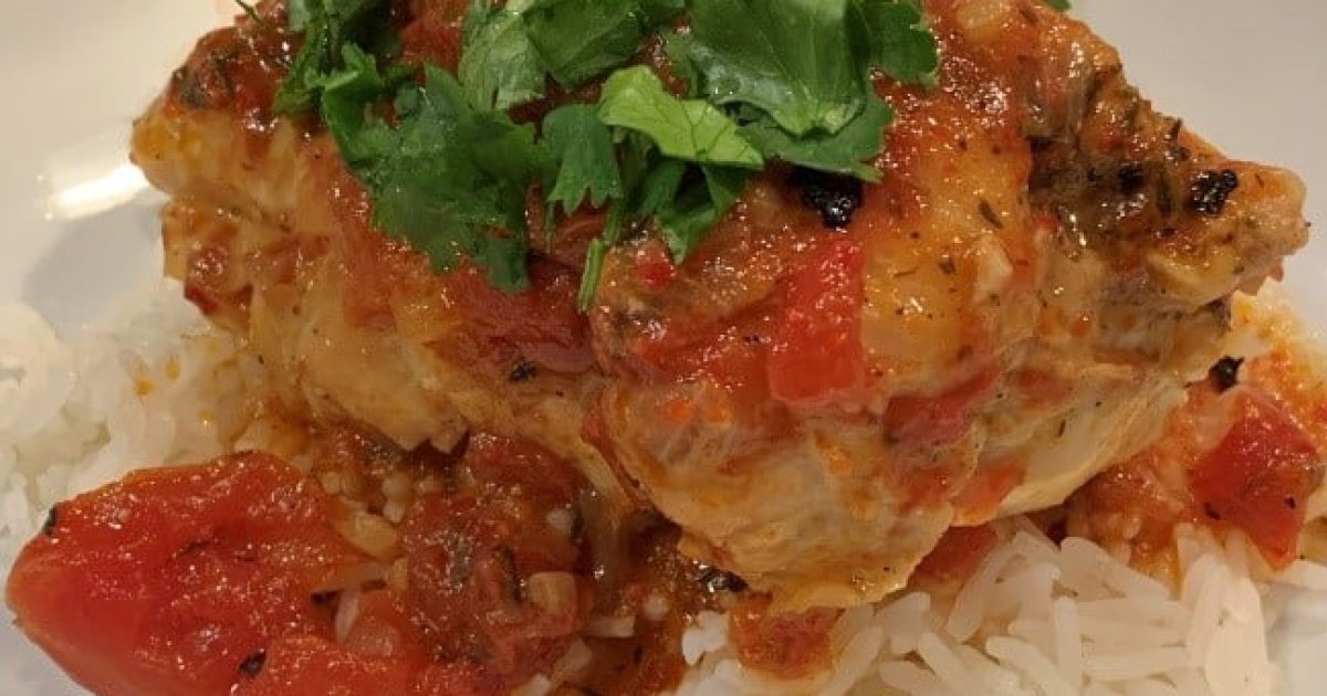 Adding cilantro to Pollo Guisado