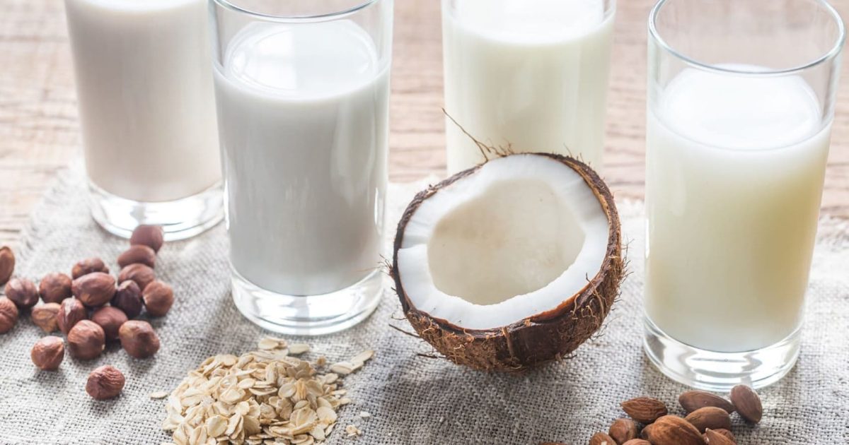 image of four glasses of non-dairy milks (oats, nuts, coconut)